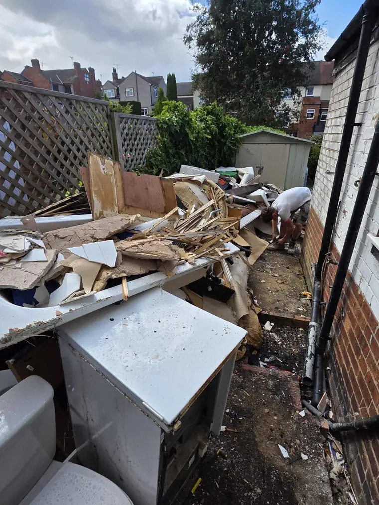 A bathroom and building strip-out being cleared from a side alley